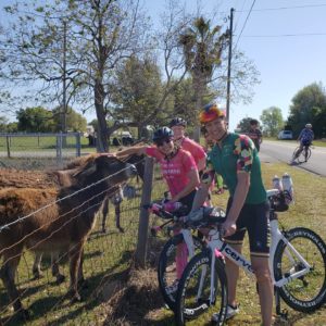 photo of triathletes stopped to take photo of donkeys 